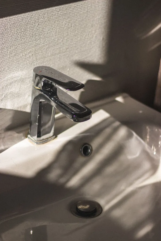 Chrome faucet on a ceramic sink — recommended for Canton hard water treatment